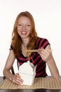 Pretty Red Head with Chinese Noodles in Chopsticks Royalty Free Stock Photo