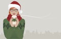 Pretty redhaired girl wearing glasses and a santa hat drinking a hot drink at Christmas.