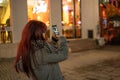 Pretty redhead girl makin a smartphone picture