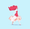 Pretty redhead girl in red dress going back from shopping with shopping bags in her hands Royalty Free Stock Photo