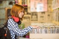 Pretty redhead searching a vinyl