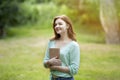 Pretty Redhead Teen Girl Daydreaming Outdoors With Book In Hands Royalty Free Stock Photo