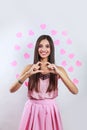 Pretty romantic young brunette indian woman making a heart gesture with her fingers in front . Valentines day concept Royalty Free Stock Photo