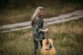 Pretty woman guitar nature fashion look concept. Royalty Free Stock Photo