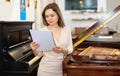 Pretty saleswoman in piano record store