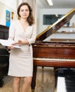 Pretty saleswoman in piano record store