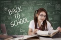 Pretty schoolgirl reads book Royalty Free Stock Photo