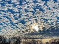 Pretty Scudding Cloud Formations and Sun in December Royalty Free Stock Photo