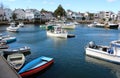 Touristy scene with fishing and row boats moving about on calm waters, Rockport, Massachusetts, 2018