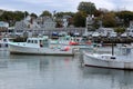 Touristy scene with fishing and row boats moving about on calm waters, Rockport, Massachusetts, 2018