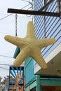 Old clapboard shingles on business exterior with starfish decorations welcoming shoppers inside, Rockport, Mass, 2019