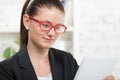 A pretty secretary looking at a digital tablet