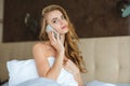 Pretty seductive woman talking on mobile phone in bed Royalty Free Stock Photo