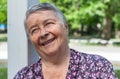 Pretty, senior woman chatting with friends, laughing outdoors, enjoying on walk outdoors in summer Royalty Free Stock Photo