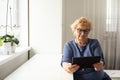 pretty senior woman using tablet computer at home Royalty Free Stock Photo