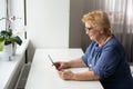 pretty senior woman using tablet computer at home Royalty Free Stock Photo