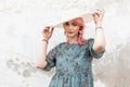 Pretty sensual lovely young woman model with pink hair in blue summer beautiful dress straightens white stylish hat near vintage Royalty Free Stock Photo