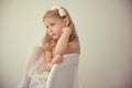 Pretty seriously ballet girl in white tutu sitting on chair