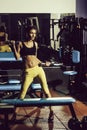 Pretty sexy woman training with metallic dumbbells