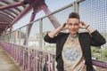 Pretty short hair girl listening to music on a bridge Royalty Free Stock Photo