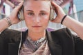 Pretty short hair girl listening to music on a bridge Royalty Free Stock Photo
