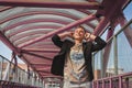 Pretty short hair girl listening to music on a bridge Royalty Free Stock Photo