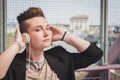 Pretty short hair girl listening to music on a bridge Royalty Free Stock Photo