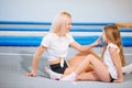 Pretty siters girls having fun indoor. Jumping on trampoline in children zone