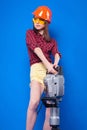 Pretty slim builder girl in red chechered shirt, build gogg Royalty Free Stock Photo