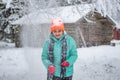 A pretty smailing face woman in a winter landscape enjoying the snow fall from the snow covered tree branches