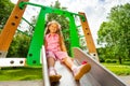 Pretty small girl on chute sitting and smiling Royalty Free Stock Photo