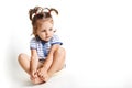 Pretty small kid with two pony tails, dressed in striped t shirt Royalty Free Stock Photo