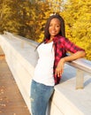 Pretty smiling african woman wearing a red checkered shirt in evening Royalty Free Stock Photo