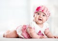 Pretty smiling baby girl lying on stomach and looking up Royalty Free Stock Photo