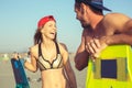 Woman kitesurfer enjoying summertime on sandy beach with her boyfriend. Royalty Free Stock Photo