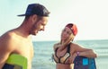 Woman kitesurfer enjoying summertime on sandy beach with her boyfriend. Royalty Free Stock Photo