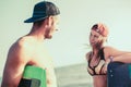 Woman kitesurfer enjoying summertime on sandy beach with her boyfriend. Royalty Free Stock Photo