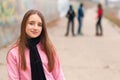 Pretty smiling girl posing outside with friends