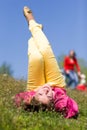 Pretty smiling girl relaxing on yellow flowers Royalty Free Stock Photo