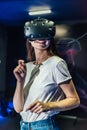 Pretty smiling girl touching her head wearing the virtual reality helmet Royalty Free Stock Photo