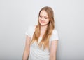 Pretty smiling joyful young woman with fair blond long hair in casual dress looking with happy. Studio shot of good looking Royalty Free Stock Photo