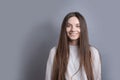 Pretty smiling joyfully female with dark hair, dressed casually, looking with satisfaction at camera, being happy. Studio shot of Royalty Free Stock Photo