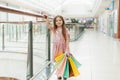 Pretty smiling little girl with shopping bags posing in the shop. Lovely sweet moments of little princess, pretty friendly child Royalty Free Stock Photo