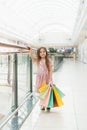 Pretty smiling little girl with shopping bags posing in the shop. Lovely sweet moments of little princess, pretty friendly child Royalty Free Stock Photo