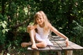 Pretty smiling pensive girl sitting on the old bridge Royalty Free Stock Photo