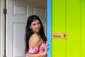 Pretty smiling seductive woman in an entrance door