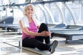 Pretty smiling senior woman sitting in a gym Royalty Free Stock Photo