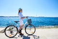 Young woman riding city bicycle near sea