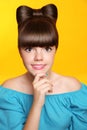 Pretty smiling teen girl with bow hairstyle, makeup and colourful manicured polish nails. Funny brunette in blue dress isolated o Royalty Free Stock Photo