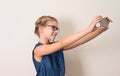 Pretty smiling teen girl in glasses making selfie photo on smart Royalty Free Stock Photo